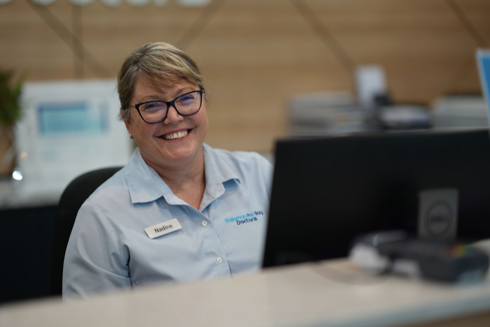 Reception staff welcoming a patient