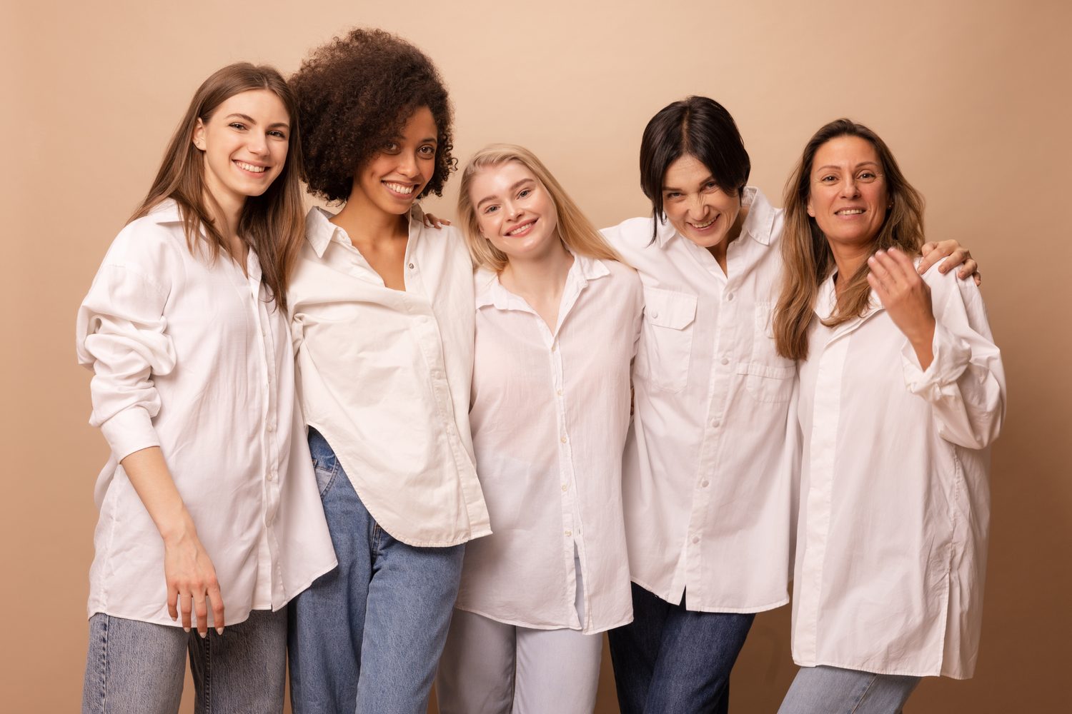 Five women of different ages standing together